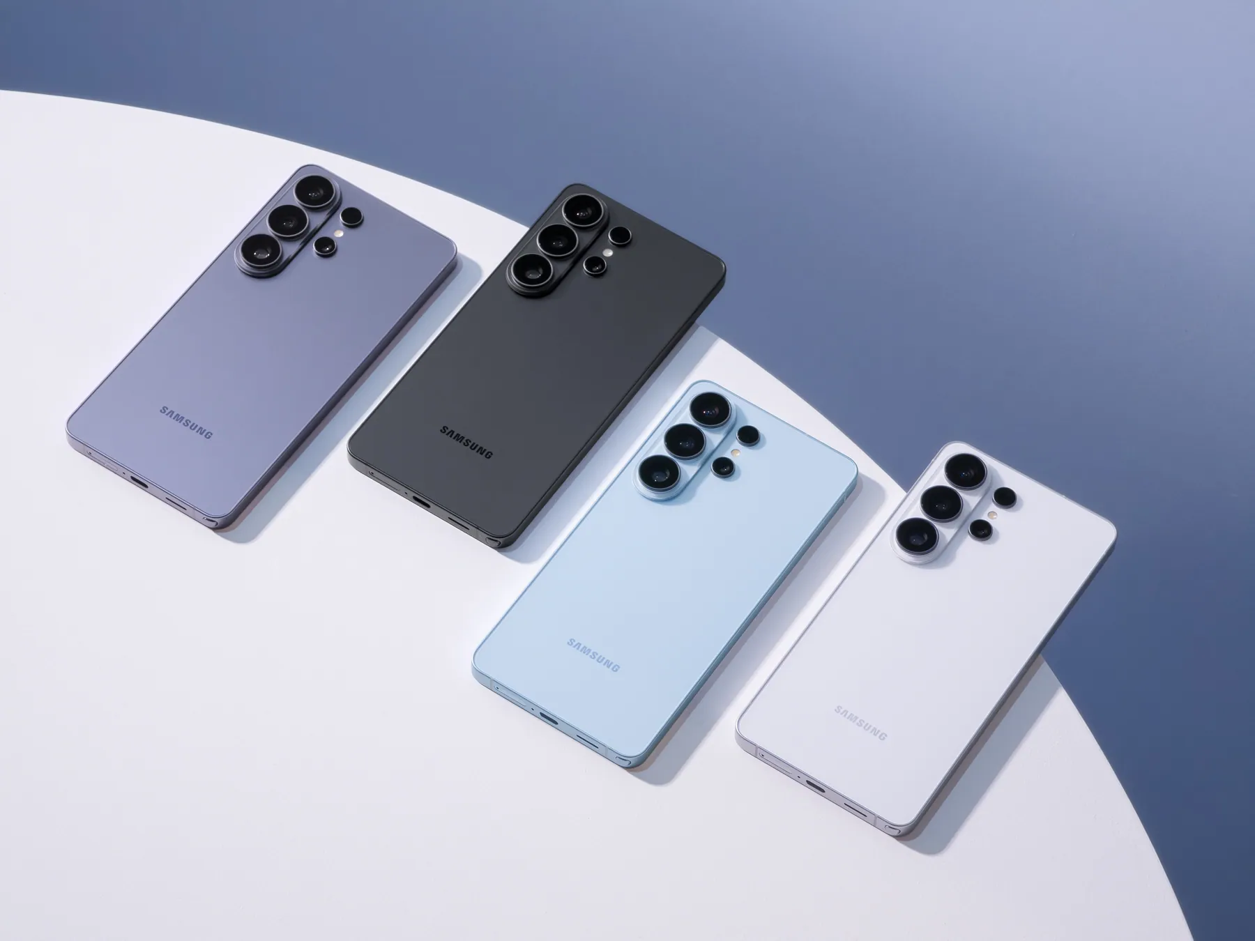 Four Galaxy S26 Ultra phones in Cobalt Violet, Black, Sky Blue and White lying on a table