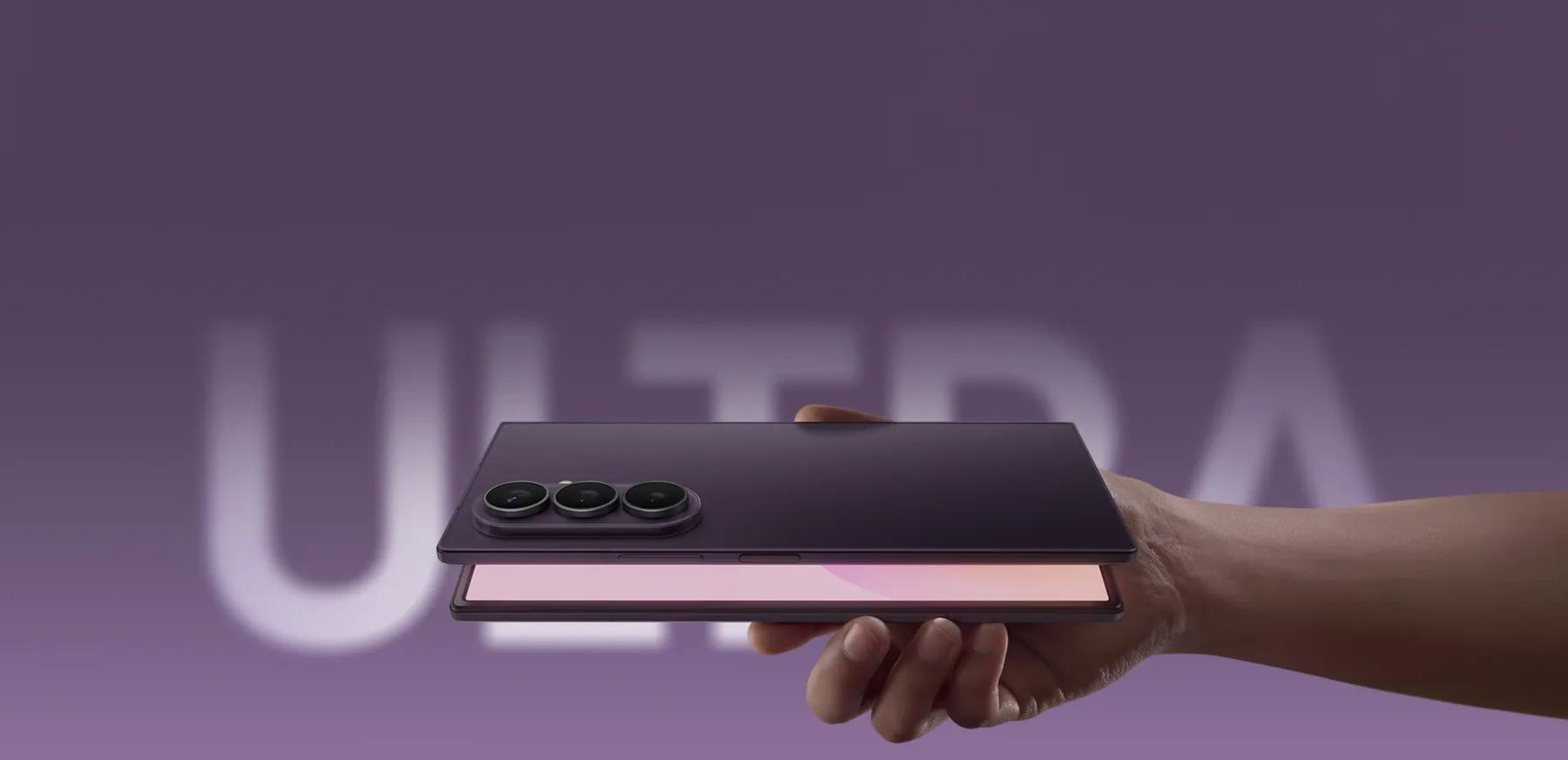 Galaxy Z Fold8 Ultra in Violet Shadow, slightly opened and held in hand in front of large ULTRA lettering