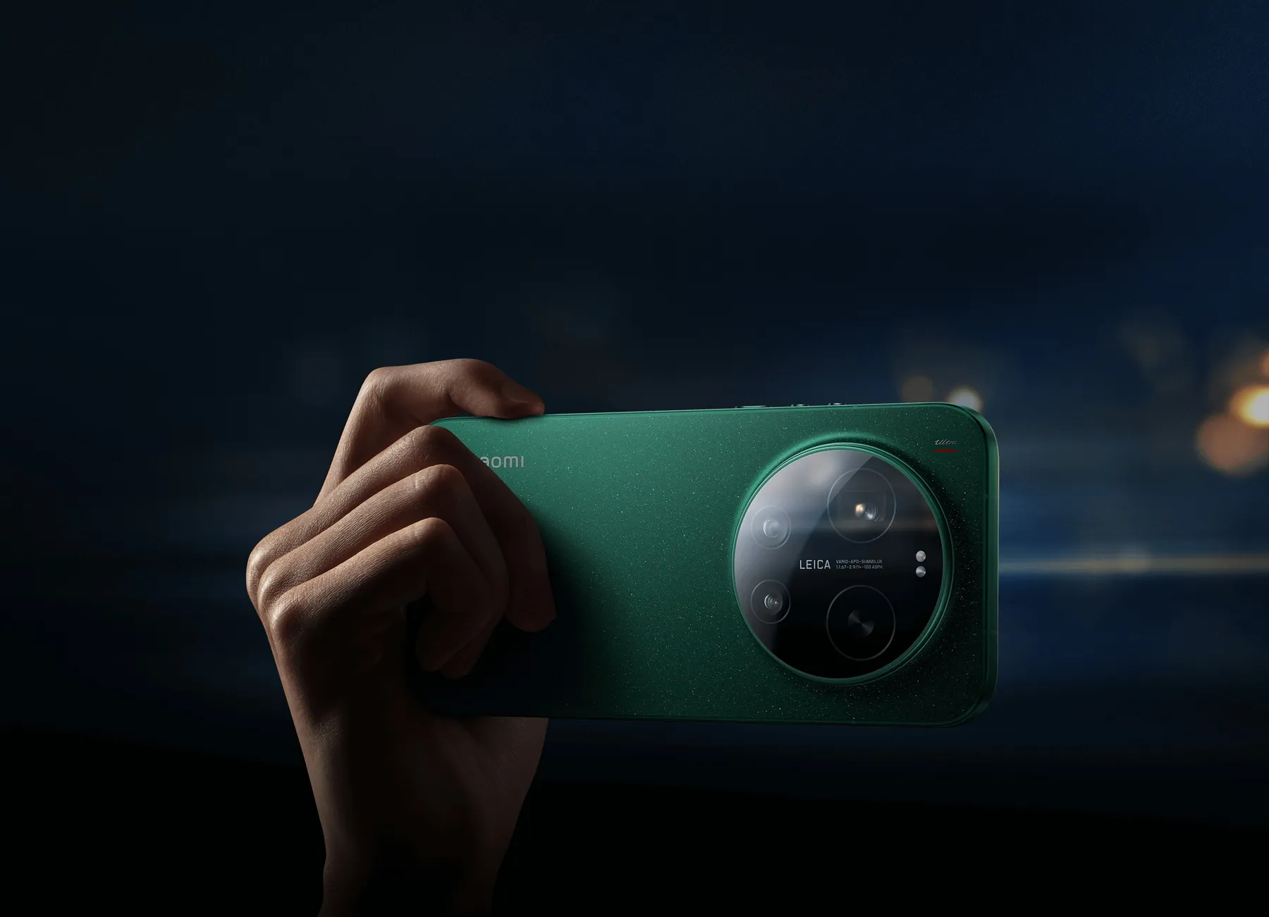 Hand holding Xiaomi 17 Ultra in Starlit Green horizontally to shoot a night scene